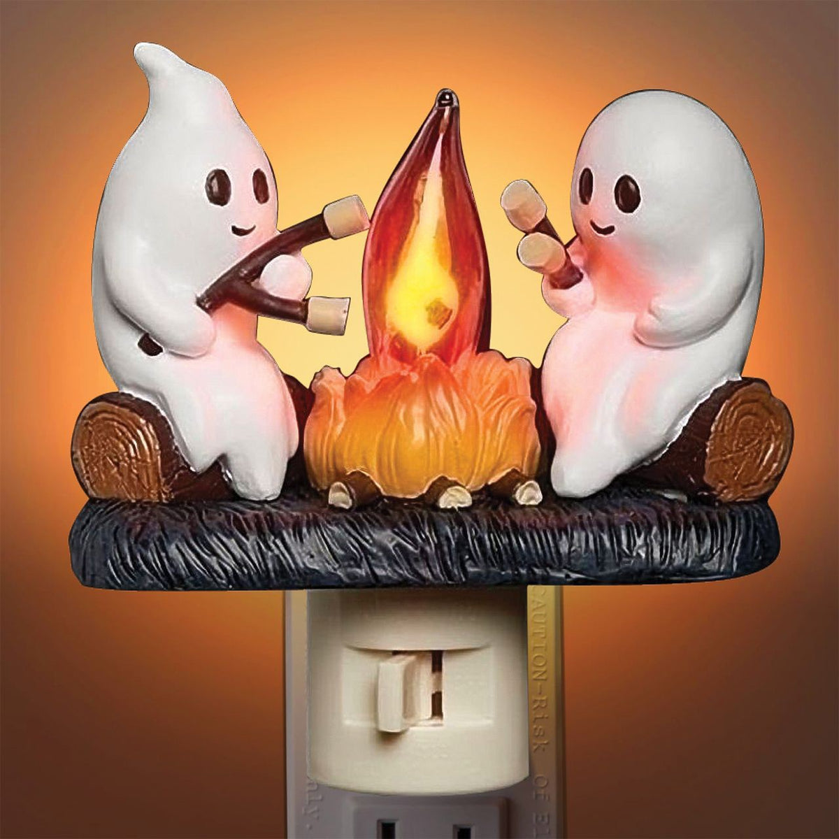 Veilleuse Halloween allumée avec une lumière orange chaleureuse, fantômes autour du feu